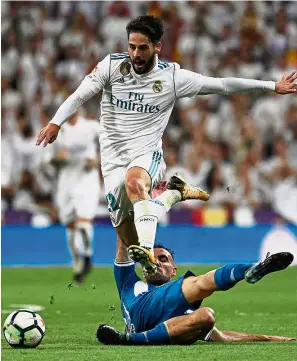  ??  ?? Up and away: Real Madrid’s Isco jumping over Espanyol’s Sergi Darder at the Bernabeu on Sunday. — Reuters