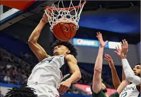  ?? Stephen Dunn / Associated Press ?? UConn's Andre Jackson, an Albany Academy grad, dunks during the first half vs. Binghamton on Saturday. The No. 23 Huskies improved to 4-0.