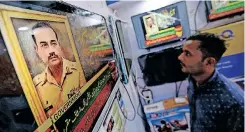  ?? | EPA ?? A MAN watches a television broadcast of the nomination of Pakistan’s new army Chief Lieutenant-General Syed Asim Munir at a market in Karachi, Pakistan, yesterday.