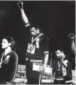  ?? (AFP) ?? In this October 16, 1968, picture, US athletes Tommie Smith (centre) and John Carlos (right) raise their gloved fists in the Black Power salute alongside Peter Norman (left) of Australia during the men’s 200m podium ceremony at the Mexico Olympic Games.