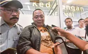  ?? AFP PIC ?? Sony Setiawan (centre) speaking to journalist­s at the Pangkal Pinang airport in Bangka Belitung province yesterday following his arrival on another airline after missing his pre-planned flight on Lion Air Flight JT610.