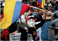  ?? AP ?? People wearing Julian Assange and Guy Fawkes’ masks protest the policies of President Lenin Moreno’s government in Quito, Ecuador, yesterday. Demonstrat­ors protested the recent firing of state workers, an IMF loan and the removal of Assange’s asylum status.