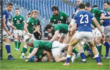  ?? Agence France-presse ?? ↑
Ireland’s Will Connors (bottom) scores a try against Italy during their Six Nations tournament match in Rome on Monday.