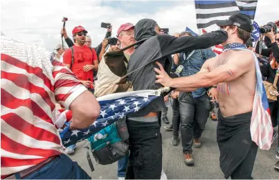  ?? AP ?? Supporters of President Donald Trump scuffle with protesters during a rally in Huntington Beach, California, on Saturday. —