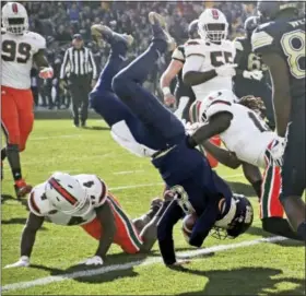  ?? KEITH SRAKOCIC — THE ASSOCIATED PRESS ?? Pittsburgh quarterbac­k Kenny Pickett (8) flips over Miami defensive back Jaquan Johnson (4) as he goes in for a touchdown in the first half of an NCAA college football game, Friday in Pittsburgh.