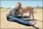  ?? EDDIE MOORE/JOURNAL ?? Nina Malone hugs her dog Sadie in a fenced play area outside the Santa Fe Animal Shelter on Thursday. Malone and Sadie were separated in Florida, but reunited in Santa Fe.