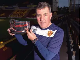  ??  ?? Reward: McGhee with his Manager of the Month award yesterday after wins over Celtic, Dundee and St Johnstone in December