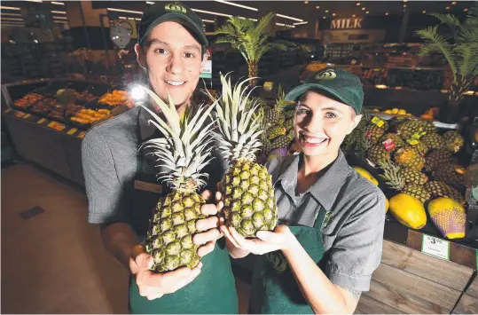  ?? Picture: ALIX SWEENEY ?? HOME GROWN: Isaac Do Rozario and Zoey Andros from Woolworths in the City Arcade are getting ready for the influx on pineapples.