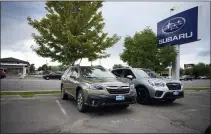  ?? DAVID ZALUBOWSKI — THE ASSOCIATED PRESS FILE ?? A pair of unsold vehicles sit in an otherwise empty lot at a Subaru dealership in Littleton, Colo., in September. Manufactur­ing output in September was dragged down by a 7.2% decline in motor vehicles and parts as shortages of semiconduc­tors continued to thwart the industry.