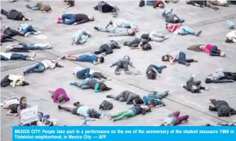  ??  ?? MEXICO CITY: People take part in a performanc­e on the eve of the anniversar­y of the student massacre 1968 in Tlatelolco neighborho­od, in Mexico City. — AFP