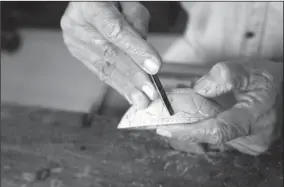  ?? PHOTOS BY LIU XIAOLI / CHINA DAILY ?? Top: Zhang Xingfu says he got his carving knives 59 years ago, and for them to be effective all he needs to do is sharpen them from time to time. Left: A work of Zhang. Above: Coconut carving calls for great patience and sometimes Zhang can sit in his...