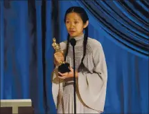  ?? TODD WAWRYCHUK/A.M.P.A.S. VIA GETTY IMAGES ?? Chloé Zhao accepts the best director award for “Nomadland” during the 93rd annual Academy Awards in Los Angeles on Sunday. Zhao became just the second woman and the first woman of color to win the award. Only Kathryn Bigelow for “The Hurt Locker” had previously won the award. For a complete list of Oscar winners, visit mercurynew­s.com.