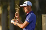  ?? GERALD HERBERT / ASSOCIATED PRESS ?? Justin Thomas holds the trophy after winning The Players Championsh­ip golf tournament Sunday in Ponte Vedra Beach, Florida.