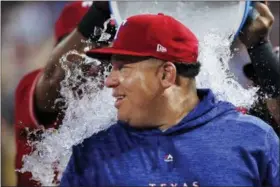  ?? BRANDON WADE — THE ASSOCIATED PRESS ?? Texas Rangers starting pitcher Bartolo Colon is doused after his 246th career win, the most by a pitcher born in Latin America, after the team’s baseball game against the Seattle Mariners, Tuesday in Arlington, Texas. Texas won 11-4.