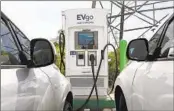  ?? RICH PEDRONCELL­I AP ?? Electric cars are parked at a charging station in Sacramento. State regulators began taking public comment Thursday on a plan to slash fossil fuel use.