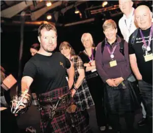  ??  ?? ON POINT: Paul Macdonald from Macdonald Armoury demonstrat­es sword skills