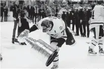  ?? AP Photo/Mark Humphrey ?? Pittsburgh Penguins center Evgeni Malkin of Russia stumbles as he carries the Stanley Cup after the Penguins defeated the Nashville Predators, 2-0, in Game 6 of the Stanley Cup Finals on Sunday in Nashville, Tenn.