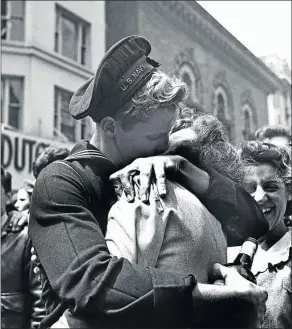  ?? Picture: GETTY IMAGES ?? RELIEF OF PEACE: A kiss in Times Square displays the mood of the world at the end of World War 2. The crowds in London were famously joined by Princess Elizabeth, who would later become queen