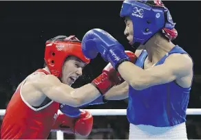  ?? JAE C. HONG/THE ASSOCIATED PRESS ?? Canada’s Mandy Bujold, left, fights China’s Cancan Ren during their quarter-finals match on Tuesday.