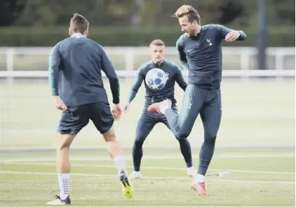  ??  ?? 2 Tottenham forward Harry Kane flicks the ball up during a training session ahead of tonight’s Champions League clash with Barcelona at Wembley.