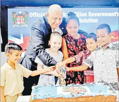  ?? Picture: JONA KONATACI ?? L-R: Prabhav Lal, Rosalie Fulford, Salailagi Kolinisau, Xavier McGoon and Osea Bainivalu help Prime Minister Voreqe Bainimaram­a cut the cake during the launch of the ePassports in Suva yesterday.