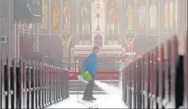  ?? AFP ?? A staff member sprays disinfecta­nt as part of preventive measures against the spread of coronaviru­s at Myeongdong Catholic Cathedral in Seoul on Wednesday. The total number of infections in South Korea had risen to more than 1,000.