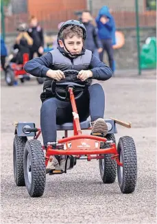  ?? ?? Friendly competitio­n Racers speed down the track