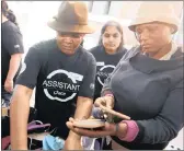  ?? PICTURES: ZANELE ZULU ?? SPOILT FOR CHOICE: Volunteers Jowie Mulaudzi, left, and Marlene Naidoo help Mhlongo choose a pair of shoes.