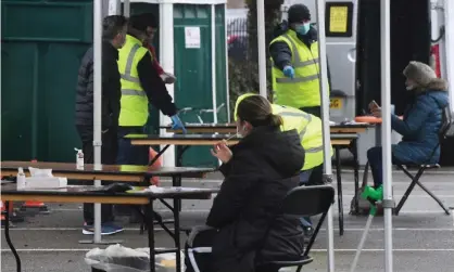  ?? Photograph: Facundo Arrizabala­ga/EPA ?? A woman takes a test in a mobile testing centre. The study suggests Covid-19 tests may be less likely to give false negative results if taken during the early afternoon compared with other times of day.