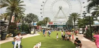  ?? SENTINEL STEPHEN M. DOWELL/ORLANDO ?? The entertainm­ent venue would be located underneath/behind the Orlando Eye.