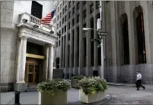  ?? SETH WENIG — THE ASSOCIATED PRESS FILE ?? A man walks toward the New York Stock Exchange.