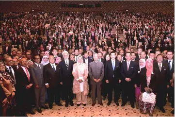  ??  ?? Dr Mahathir (front, seventh right) in a group photo at the convention. — Bernama photo