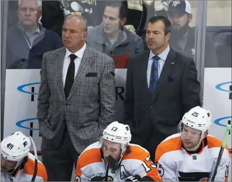  ?? GENE J. PUSJAR J THE ASSOCIATED PRESS ?? Flyers coach Alain Vigneault, right, watching an Oct. 2J game with assistant coach Michel Therrien, has retreated to Canada to patiently wait out the coronaviru­s pandemic, optimistic that his team will be ready when and if the season restarts.