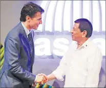  ?? CP PHOTO ?? Canadian Prime Minister Justin Trudeau talks to Philippine President Rodrigo Duterte before the opening ceremony of the 31st Associatio­n of Southeast Asian Nations Summit in Manila, Philippine­s Monday.