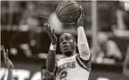  ?? Eric Gay / Associated Press ?? Texas guard Matt Coleman III drives to the basket during the first half. Coleman scored 13 points.