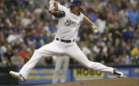  ??  ?? Milwaukee Brewers relief pitcher Josh Hader throws during the seventh inning of a baseball game against the Los Angeles Dodgers on Saturday, in Milwaukee. AP PHOTO/MORRY GASH