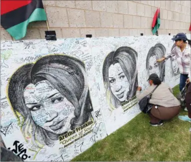  ?? PAUL SANCYA — THE ASSOCIATED PRESS ?? People sign boards with personal messages outside the Charles H. Wright Museum of African American History during a public visitation for Aretha Franklin in Detroit, Wednesday. Franklin died Aug. 16, 2018 of pancreatic cancer at the age of 76.