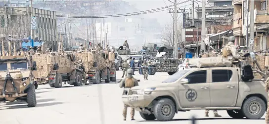  ?? REUTERS ?? Afghan security forces secure the perimeter of a Sikh-Hindu temple in central Kabul yesterday.