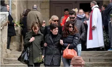  ?? — AFP photo ?? Relatives of a victim leave the service of remembranc­e at the Saint Etienne Church in Trebes.