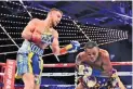  ??  ?? STEVEN RYAN/GETTY IMAGES Vasyl Lomachenko (L) lands a punch as Guillermo Rigondeaux desperatel­y attempts to dodge it in their bout on December 9, 2017.