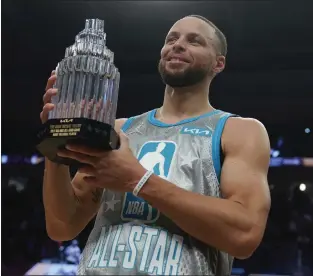  ?? CHARLES KRUPA — THE ASSOCIATED PRESS ?? Golden State Warriors' Stephen Curry holds up the Kobe Bryant Trophy after being named the MVP of the NBA All-star basketball game, Feb. 20 in Cleveland.