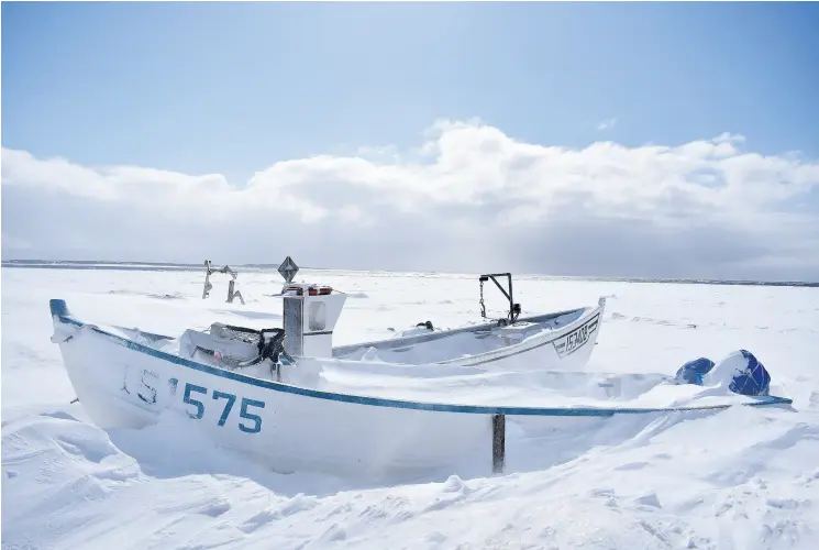  ?? COURTESY AARON BESWICK ?? Small open fishing boats in Anchor Point on Newfoundla­nd’s Northern Peninsula wait for the ice to clear out of the Strait of Belle Isle.