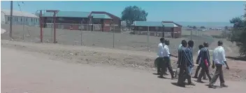  ?? Picture: LULAMILE FENI ?? MAJOR BLOW: Some of Clarkbury grade 12 pupils after finishing writing exams on Thursday, walking past the hostel they were removed from on Tuesday.