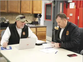  ?? Brodie Johnson • Times-Herald ?? The Forrest City Fire Department underwent fire insurance inspection­s on Wednesday to determine the new ISO rating for Forrest City. ISO inspector Greg Gordon, left, and FCFD Chief Shane Dallas review data during a portion of the inspection.