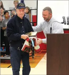  ??  ?? Chris Snow (right) presented a plaque to his grandfathe­r, Bill Snow Sr., Navy veteran, during the annual Veterans Day Assembly at Pea Ridge High School Oct. 11. Snow Sr. served as Grand Marshal of the Veteran’s Parade Saturday, Nov. 7.