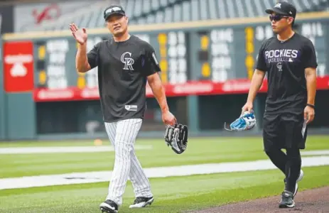  ?? David Zalubowski, The Associated Press ?? Rockies relief pitcher Seunghwan Oh, left, heads back to the clubhouse with his interprete­r, Eugene Koo, after warming up before a game against the Oakland Athletics last month.