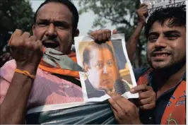  ??  ?? An activist of the Hindu nationalis­t Shiv Sena party points a trident at a photograph of Pakistan Prime Minister Nawaz Sharif on Monday as they protest against Sunday’s attack. PICTURE: AP
