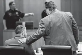  ?? Brett Coomer / Staff photograph­er ?? Defense attorney Scot Courtney reassures Terry Thompson during the start of his retrial. His first trial ended when a jury deadlocked on whether he committed murder or acted in self-defense when he choked a fellow restaurant patron.