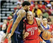  ?? [AP PHOTO] ?? Houston Rockets forward P.J. Tucker, right, is fouled by Oklahoma City Thunder forward Paul George during a Christmas Day game in Houston The Rockets won the game, 113-109.