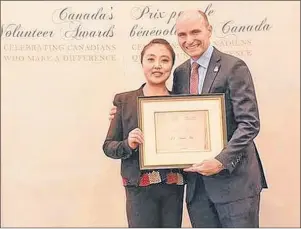  ?? SUBMITTED PHOTO ?? Li Yuan Ma receives the Community Leader, Atlantic Region award from the Jean-Yves Duclos, federal minister of Families, Children and Social Developmen­t recently in Ottawa. Ma planned to donate the $1,000 grant associated with her recognitio­n package...